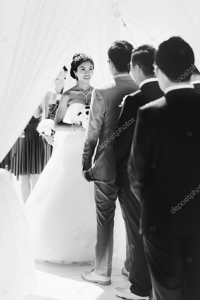 stylish rich smiling asian bride and groom