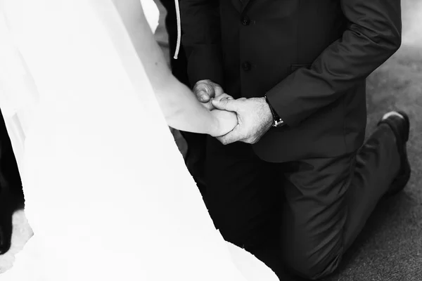 Groom in a suit holding a hand — Stock Photo, Image