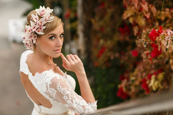 Bride with orchids on the stairs — Stockfoto