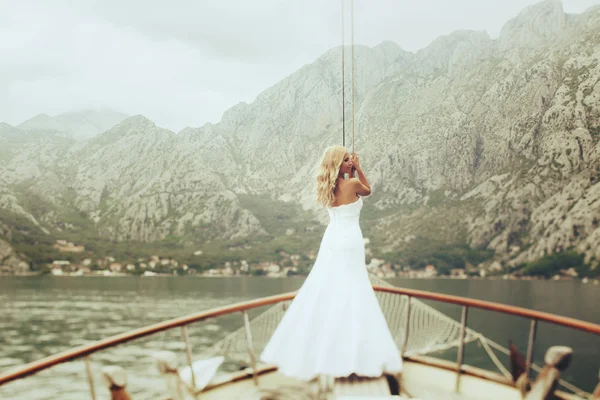bride posing on the deck of a yacht