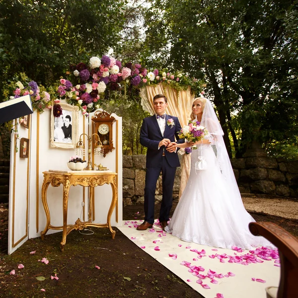 Happy bride and groom holding hands — Stock Photo, Image