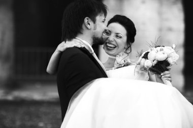 cute rich happy groom holds