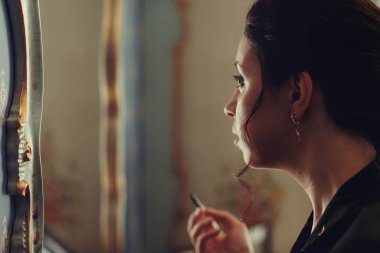 wonderful stylish bride doing makeup