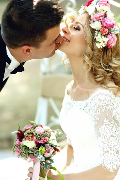 Novia en vestido blanco besando novio — Foto de Stock