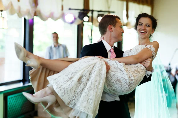 Strong groom holding beautiful bride — Stock Photo, Image