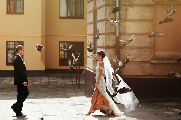 bride walking to handsome groom