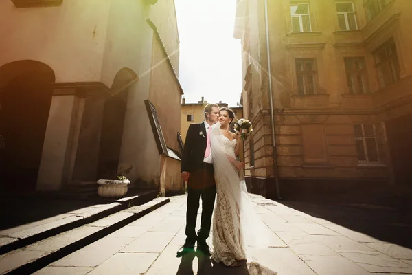 Νύφη με πέπλο παρουσιάζουν σε εξωτερικούς χώρους με γαμπρός — Φωτογραφία Αρχείου