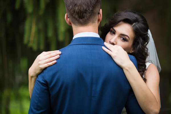 Happy bride hugging handsome groom — Stock Photo, Image