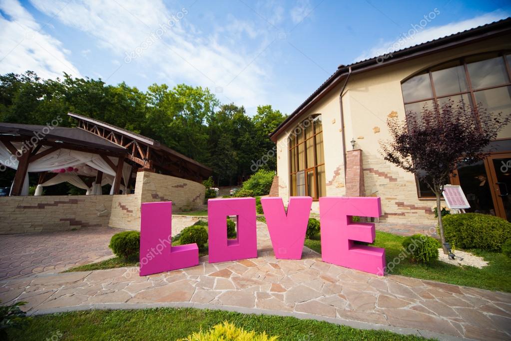 Stylish large pink Love sign, with big romantic letters, creative wedding decoration