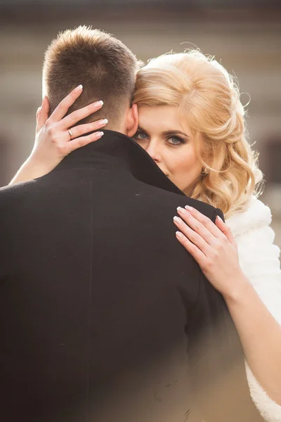 Bride kissing handsome groom — Stock Photo, Image