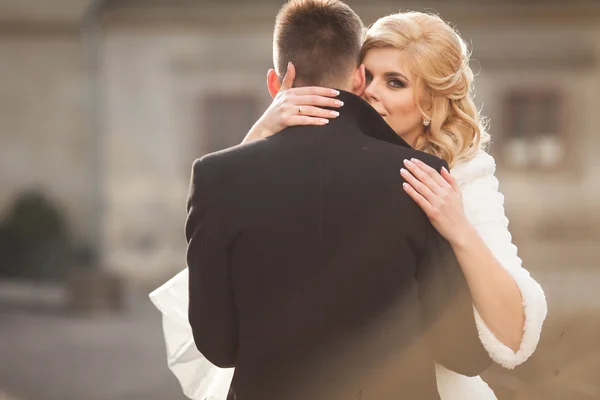 Bride kissing handsome groom — Stock Photo, Image