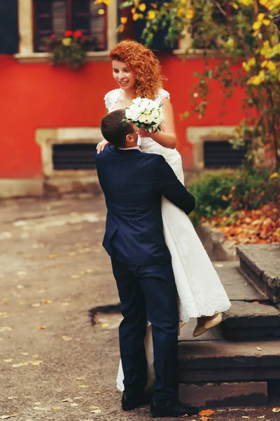 Groom hugging bride — Stock Photo, Image