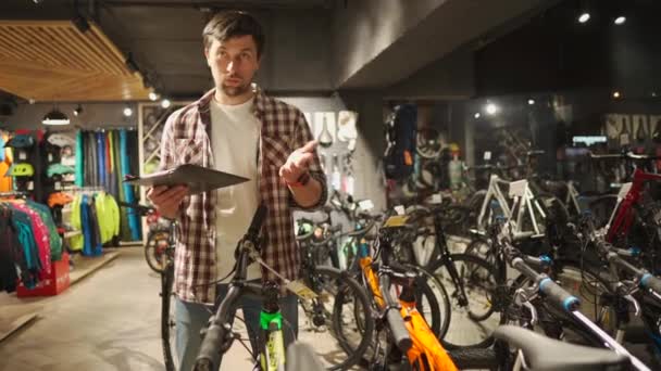 자전거 판매원들은 스포츠 용품 점의 고객들에게 자전거를 추천 한다. 사이클 스토어 컨설팅. 자전거 가게 주인은 손님이 자전거를 선택하도록 도와 준다. 대화에서 매니저를 저장 합니다. 상담가는 자전거를 고객에게 보여 주고 — 비디오