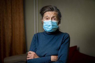 Wise look of old woman with medical mask on face encourages you to keep your distance and use protective equipment, health safety during an covid 19. Portrait of senior looking at camera, elderly care clipart