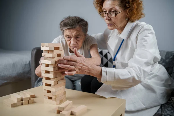 Senior Woman Playing Jenga Build Tower Blocks Elderly Doctor White — Stock Photo, Image