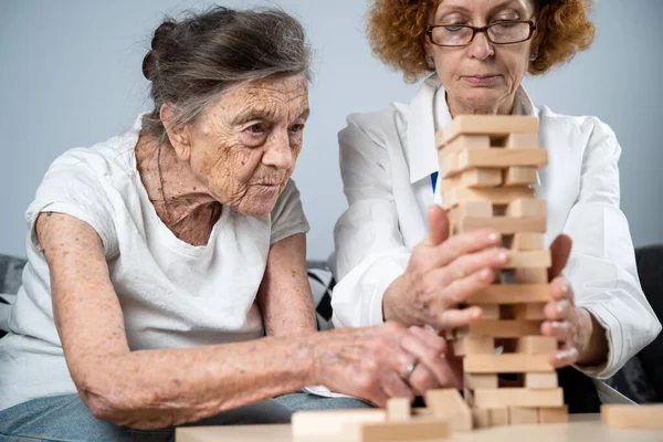 Senior Woman Practice Skills Build Wooden Blocks Build Tower Try — Stock Photo, Image