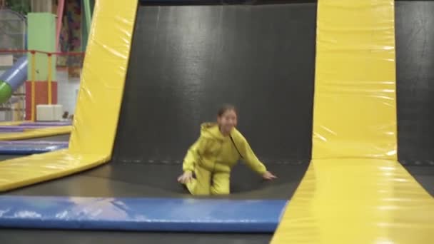 Children active leisure. Sports weekend in sports center of acrobatics and trampoline. Physical education. Children having fun on trampoline in entertainment center, childhood and sporty lifestyle — Stock Video