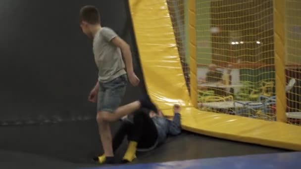 Children active leisure. Sports weekend in sports center of acrobatics and trampoline. Physical education. Children having fun on trampoline in entertainment center, childhood and sporty lifestyle — Stock Video