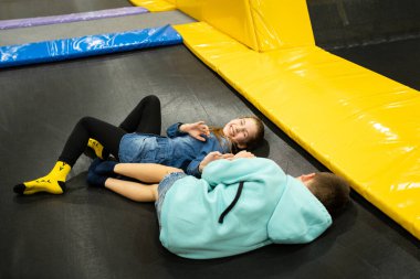 Children are active leisure. Sports weekend in sports center of acrobatics and trampoline. Physical education. Children having fun on trampoline in entertainment center, childhood and sporty lifestyle