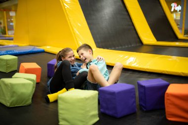 Children are active leisure. Sports weekend in sports center of acrobatics and trampoline. Physical education. Children having fun on trampoline in entertainment center, childhood and sporty lifestyle