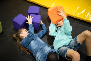 Children are active leisure. Sports weekend in sports center of acrobatics and trampoline. Physical education. Children having fun on trampoline in entertainment center, childhood and sporty lifestyle