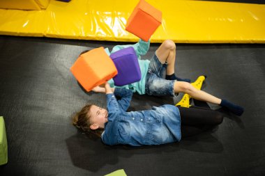 Children are active leisure. Sports weekend in sports center of acrobatics and trampoline. Physical education. Children having fun on trampoline in entertainment center, childhood and sporty lifestyle