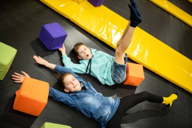 Children are active leisure. Sports weekend in sports center of acrobatics and trampoline. Physical education. Children having fun on trampoline in entertainment center, childhood and sporty lifestyle