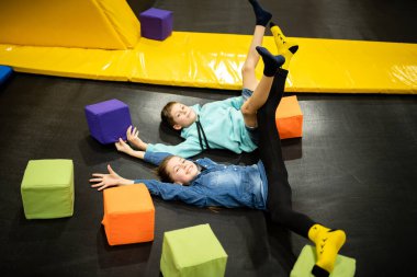 Children are active leisure. Sports weekend in sports center of acrobatics and trampoline. Physical education. Children having fun on trampoline in entertainment center, childhood and sporty lifestyle
