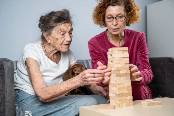 Retired Mother Daughter Spend Time Together Home Playing Board Game — Stock Photo, Image