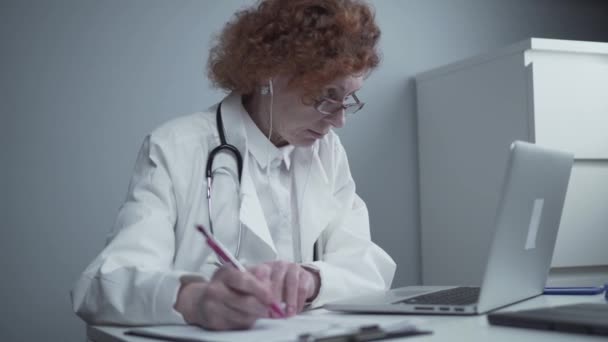 Operatrice sanitaria femminile che offre cure mediche online. Assistente medico indossa cuffie video chiamata paziente lontano sul computer portatile. Il concetto di telemedicina. Incontri virtuali app appuntamento medico online — Video Stock