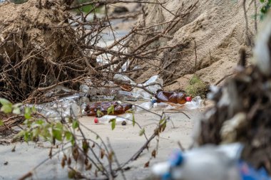 Environmental problem caused by human activity. Trash tourism. Pollution of Kiev Sea in Ukraine. Plastic garbage on shore of pond. Rubbish and waste left by bad people after vacation on dnieper river