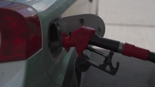 Primer plano de repostaje de coches en el servicio de gasolinera. Escotilla abierta del tanque de combustible del coche con la bomba con combustible, repostando el coche con gasolina en la gasolinera. Pistola diesel en el tanque del coche, repostaje del coche. Tema industrial — Vídeos de Stock