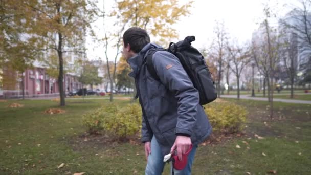 Hombre propietario de perro lostin el parque y está buscando para atraer a animales de compañía tratar para ella con hueso. Hombre buscando una mascota desaparecida. El macho está muy molesto porque su amado perro huyó, él la llama en el parque — Vídeos de Stock