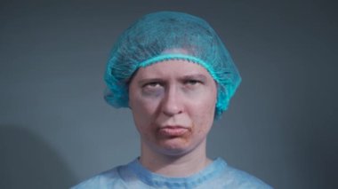 Aile içi şiddet. Savunmasız kurbana fiziksel zarar verme. Hastanede ağlayan portre kadın. Yüzü ve diş yaralanmalarıyla kameraya bakıyor. Hastanedeki kadın kazadan sonra giyiniyor.