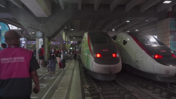 Fransa, Paris, 21 Ağustos 2021. Koronavirüs zamanındaki Gare du Nord tren istasyonunda koruyucu maskeli insanlar TGV treni boyunca yürür. Platformda Gare du Nord 'dan geçen yolcular — Stok video