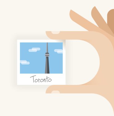 Tourist hands holding photography of the CN tower, which is located in Toronto, Canada. Idea - Canada capital city, tourism, travel, landmarks. clipart