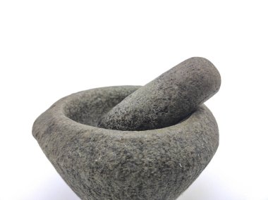 A traditional stone mortar and pestle on white background. Selective focus points