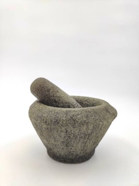 A traditional stone mortar and pestle on white background. Selective focus points
