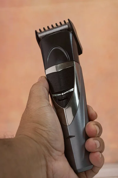 Cordless hair trimmer. During the pandemic when barbershops are closed, more men bought the devise to cut their own hair. Selective focus points. Blurred background