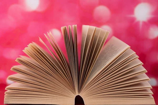 Close-up of an open book creating fan shape. Selective focus points. Blurred background