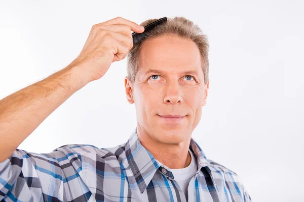 Knappe vrolijke leeftijd man kammen zijn haren — Stockfoto