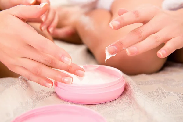 Close up photo of two young girls smearing cream on their hands — Stock Photo, Image