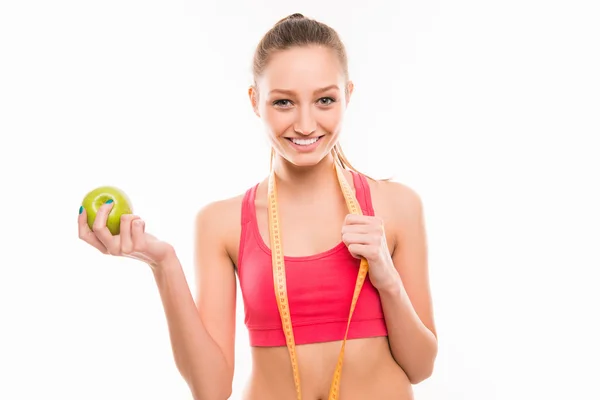 Deportiva chica con cinta métrica y manzana verde — Foto de Stock