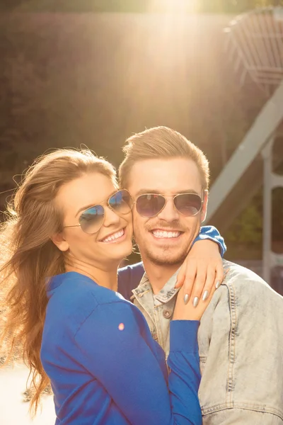 Cheerful romantic couple in love on the bridge huging together — Stock Photo, Image