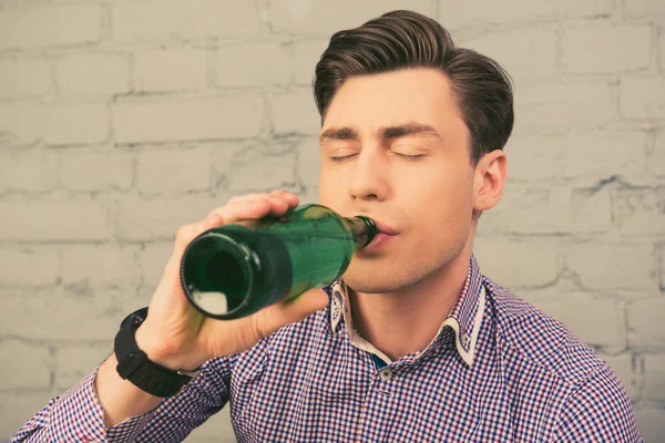 Close up portrait of attractive man drinking beer with closed ey — Stock Photo, Image