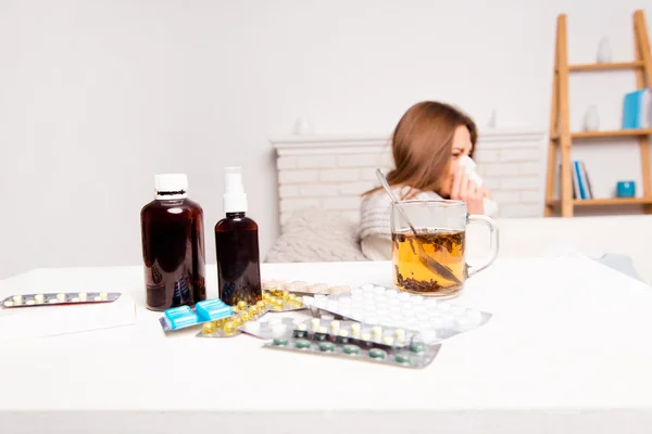 Close up photo of cup of tea, pills and mixture. sick woman's tr — Stock Photo, Image