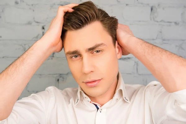 Close up portrait of handsome man combining his hair — Stock Photo, Image