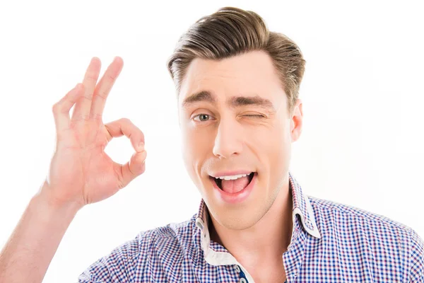 Handsome happy young man gesturing "OK" and winking — Stock Photo, Image