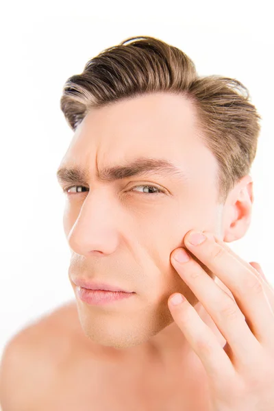 Close up photo of young man looking for acnes on his cheek — Stock Photo, Image