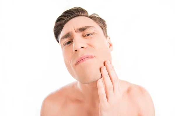 Skincare. Young man inspecting his face after shave — Stock Photo, Image